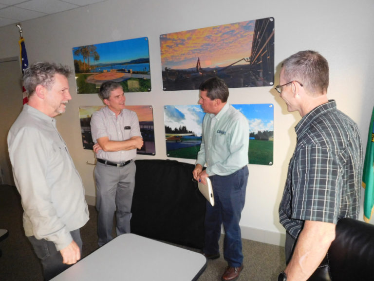 Jim Kalvelage and Mark Stoller (foreground), with Opsis Architecture, Washougal City Administrator David Scott and Camas City Administrator Pete Capell (background) talk after a Camas-Washougal Community Center Study Advisory Committee meeting, Sept. 5, 2018, in the Port of Camas-Washougal office.