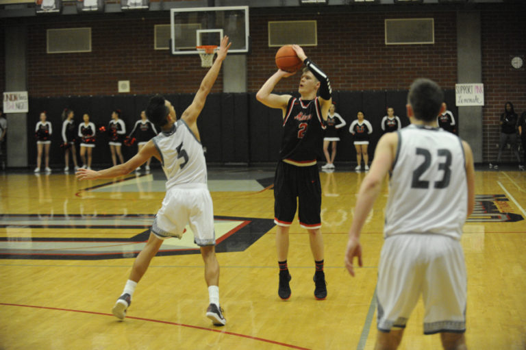 Camas High senior Carson Bonine takes a shot from 3-point land at a game against Union High on Dec. 17.