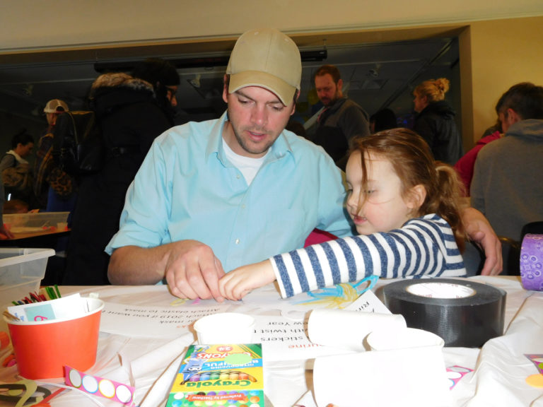 Josh Stahly and his daughter, Lydia Stahly, 4, of Vancouver, make a mask and balloon popper during the &quot;Noon Year&#039;s Eve&quot; party, Monday, Dec. 31, at the Camas Public Library.