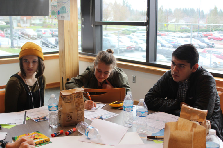 From left to right, Olivia Ernst, 15, Kari Lewis, 16, and Cesar Robles, 18, all students at Columbia High School in White Salmon, Wash., discuss regional policy-making issues at a Dec.