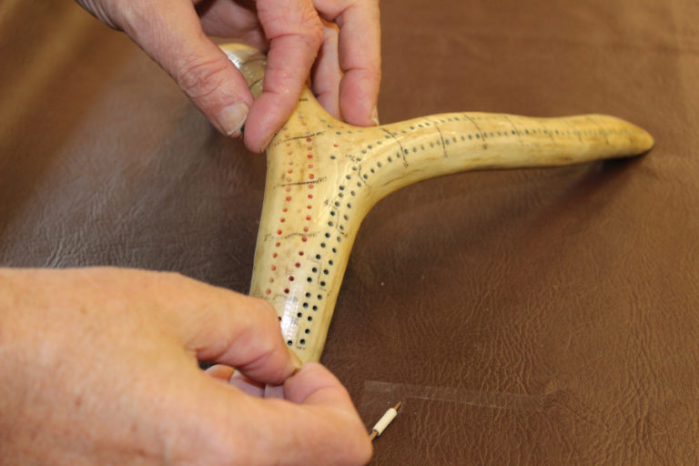 Washougal Senior Center volunteer Charlie Walker shows a cribbage board he crafted out of a found deer antler.