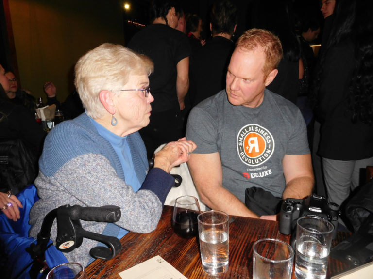 Former Camas Mayor Nan Henriksen (left) talks with Cameron Potts (right), vice-president of public relations of Deluxe Corporation, during a Jan.