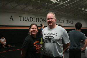 Heather and John Carver at a recent Washougal wrestling practice. Heather Carver (left) coaches the Washougal girls wrestling team while her husband, John (right), leads the boys wrestling program. 
