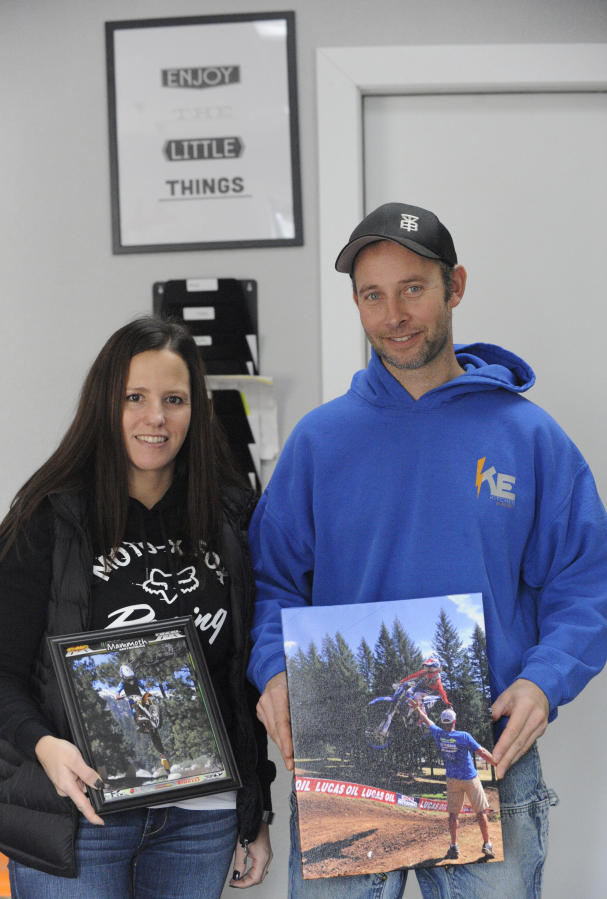 Washougal residents Sara and Paul Kitchen hold up some of their favorite pictures of their son, Levi, who is now training for motocross full time in Louisiana.