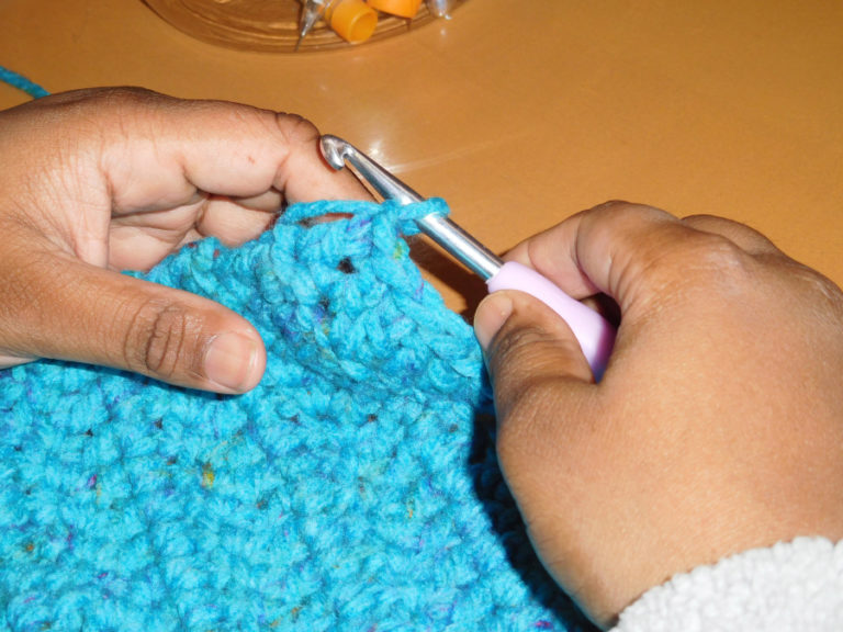 Debika Finucane, of Washougal, uses a hook and yarn to create blanket squares while attending Crochet Club at the Camas Public Library.