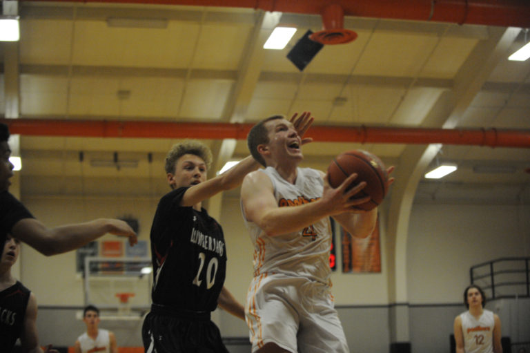 Washougal senior guard Carter Murray shakes off a defender and hits a last second game winning layup against R.A.