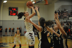 Washougal's Beyonce Bea makes a jump shot look easy over three Woodland defenders in a 71-39 win to clinch the league championship in front of a packed Panther home crowd. 