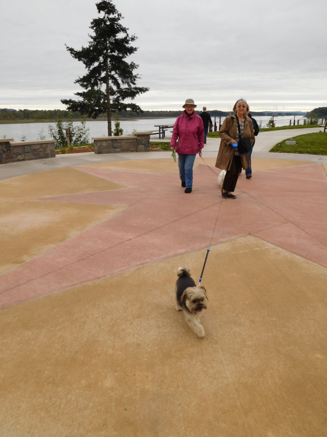 Walkers and their dog enjoy a stroll at Washougal Waterfront Park and Trail. Local residents have expressed interest in seeing restaurants and coffee shops, as well as office buildings, a performing arts center and a specialty grocery store open near the waterfront.