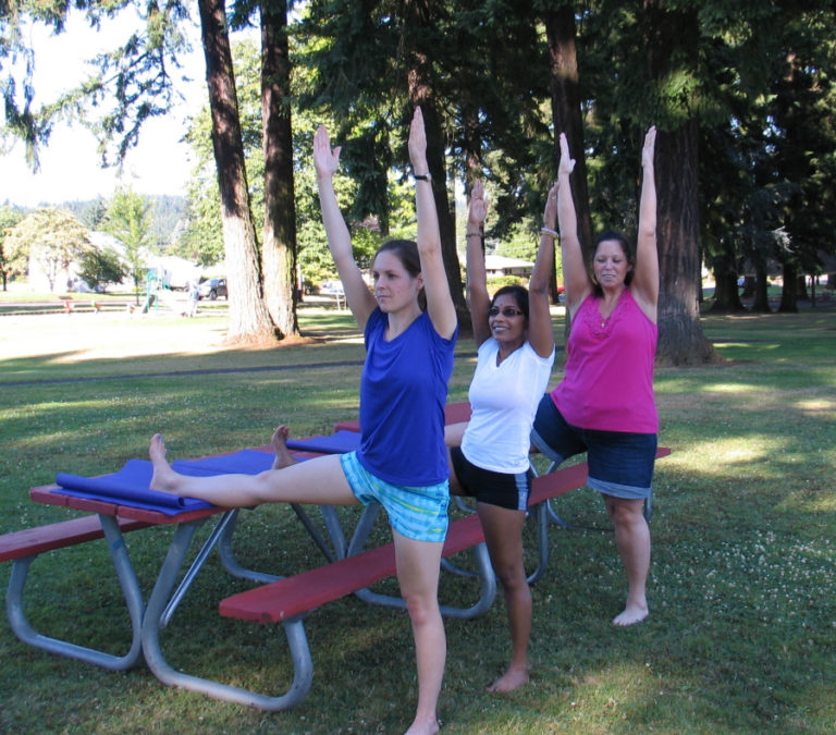 Rushing Water Yoga students practice Iyengar yoga outside during warmer weather months.