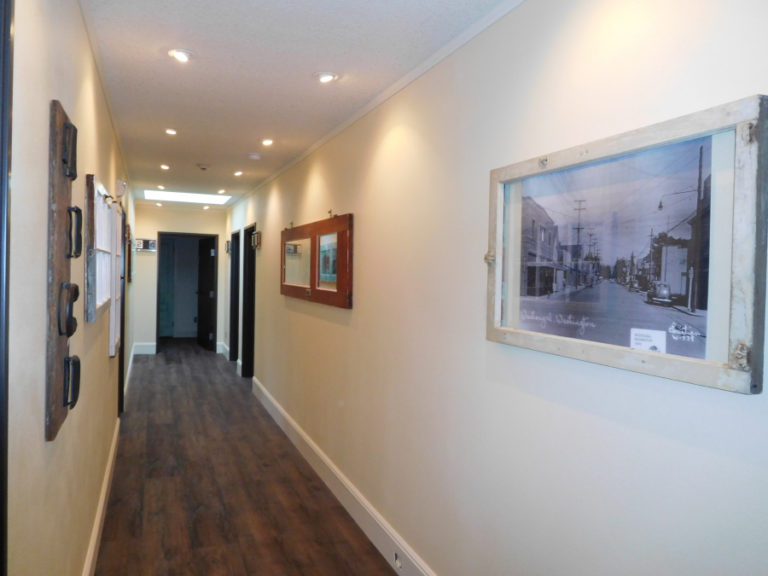 Framed photographs in the Blair Lofts hallway include an image of the McFarland Apartments in the Blair Building in 1949.