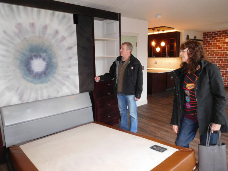 Bruce and Heidi Kramer, owners of the Blair Building since 2006, look at a mural that Heidi painted above a Murphy bed headboard, in one of the Blair Lofts. They spent three years rebuilding and transforming the second floor of the Blair Building into live/work studios, and the first apartment tenant moved in Feb. 8.