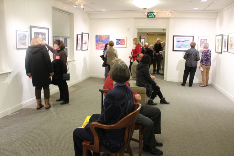 A group of First Friday celebrants peruse the art inside the Second Story gallery on Feb. 1, the opening night of the Southwest Washington Watercolor Society&#039;s two-month group show at the Camas gallery.