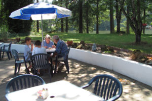 Diners enjoy eating on the Lakeside Chalet restaurant's patio overlooking Lacamas Lake, in Camas, on a summer day. Nick and Paula Stanley (not pictured) recently sold the restaurant to Charles and Janessa Stoltz. (Post-Record file photo)