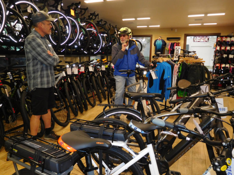 Ed Fischer, owner of Camas Bike and Sport (left), talks with Wayne Hodgin (right), Monday, Feb. 18. Fischer is a fervent supporter and fundraiser for a Washougal-based bike park inside Hamllik Park.