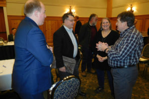 Brian Vanneman and Wally Hobson of the Portland-based Leland Consulting Group, talk with Martha Martin, of Washougal, and Port of Camas-Washougal Commissioner Larry Keister, Friday, Feb. 15, during a break of the port's strategic and capital planning retreat at The Heathman Lodge, in Vancouver. Vanneman and Hobson are working with the port to oversee the selection of a firm to develop more than 26 acres near Washougal Waterfront Park and Trail.