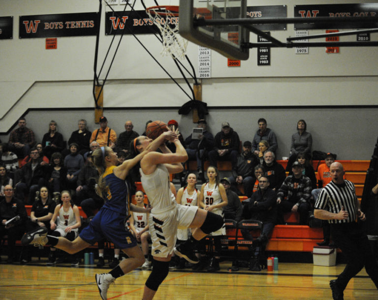 Washougal senior Beyonce Bea is fouled hard as she breaks away for a layup against Rochester in the opening game of the district playoffs on Wednesday, Feb.