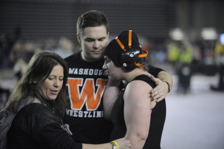 Washougal girls wrestler Emily Eakin is comforted after missing a trophy by one match.