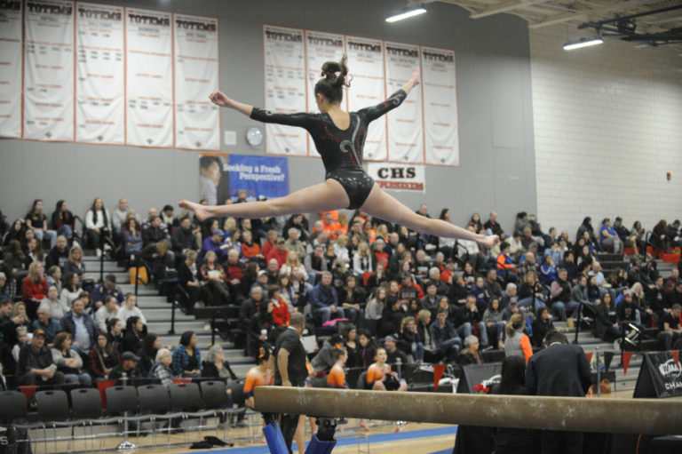 Camas sophomore Lili Ford goes airborne over the beam in front of a packed crowd at Sammamish High School on Friday, Feb.