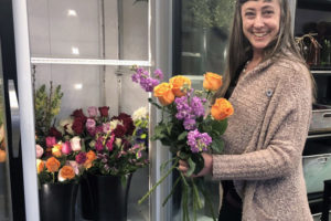 Coventry Gardens of London owner Rachel Bakker shows off one of her favorite flower combinations, orange roses with lavender stock, at her Camas-based floral studio, located at 602 N.E. Third Ave. 