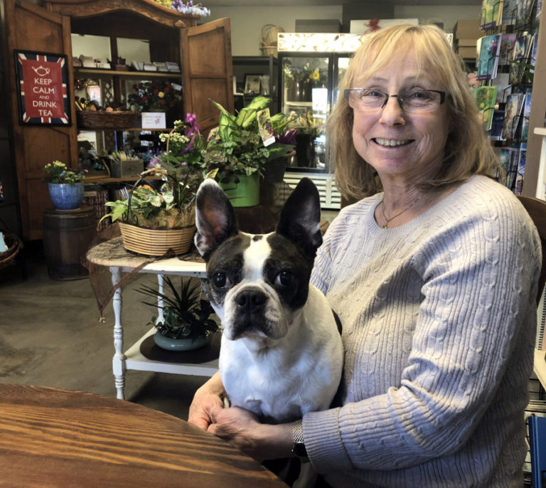Sandy Bakker, the founder of Coventry Gardens of London, sits inside her daughter, Rachel Bakker&#039;s, new floral design studio with Rachel&#039;s 12-year-old dog, Coco, on Friday, March 1.