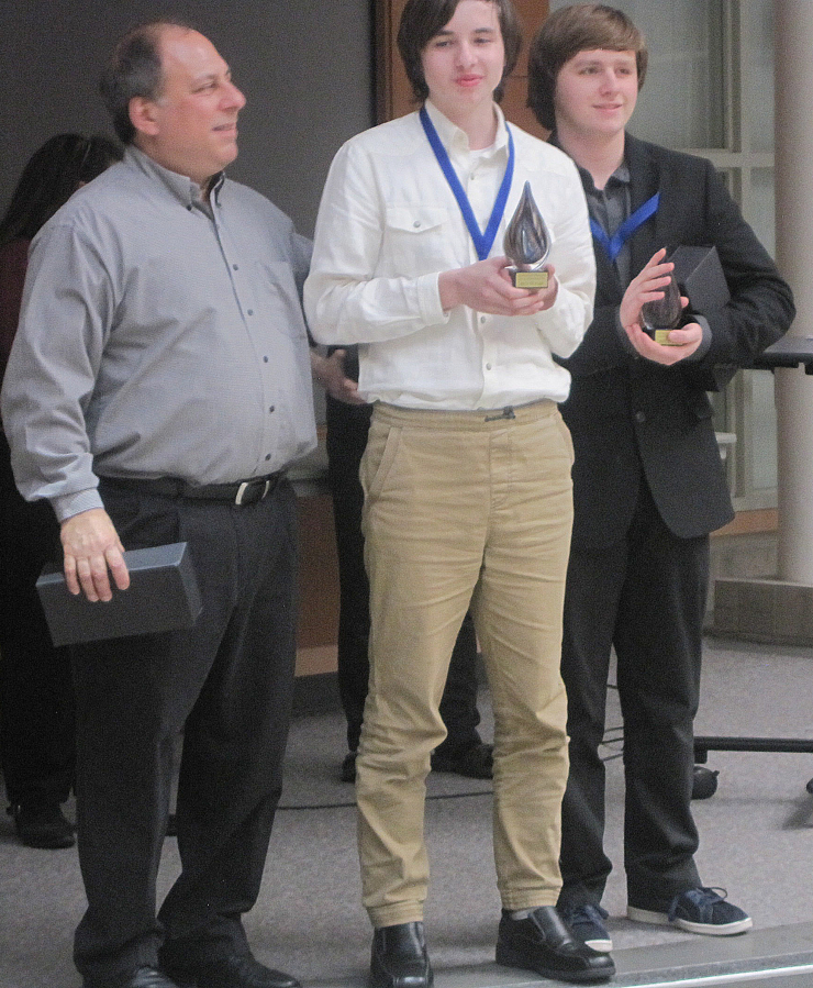 Camas High School students Gareth Starratt (center) and Juliam McOmie (right) receive their &quot;Best in Fair&quot; award at the end of the Southwest Washington Science and Engineering Fair on Saturday, March 2.