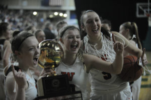 Washougal seniors (from left to right) Kiarra Cross, Ashley Gibbons and Beyonce Bea celebrate their team's state title at the 2A Hardwood Classic in Yakima, Wash., on Feb. 28.