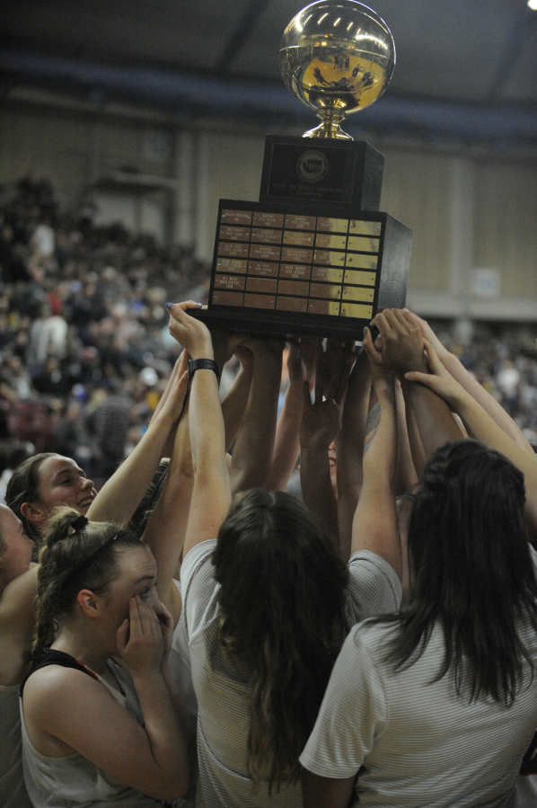 The entire Panthers team hoists the state championship trophy in front of their loyal fans who made the trip to witness history at the Yakima Valley SunDome.