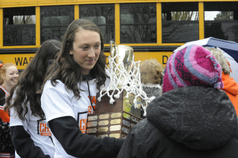 Clutching the state championship trophy, senior Beyonce Bea spends some time sharing her experience with community members who gathered in downtown Washougal to celebrate the girls basketball team&#039;s historic accomplishment.