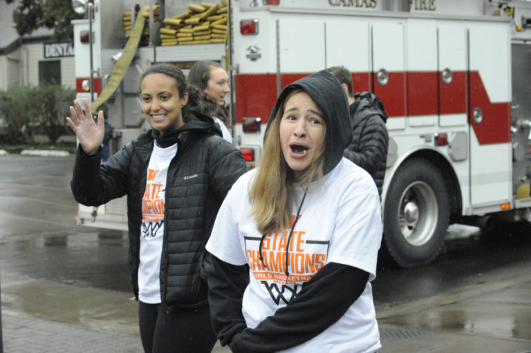 Head girls basketball coach Britney Knotts (right) is warmed up by a cheering crowd in downtown Washougal.