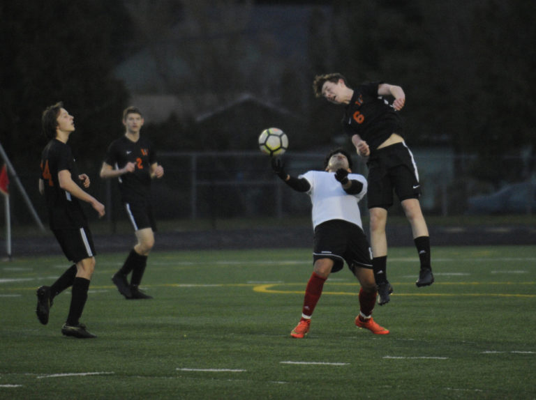 Washougal freshman Mason VanNostern uses his head to gain control of the ball from a White Salmon player on March 14.