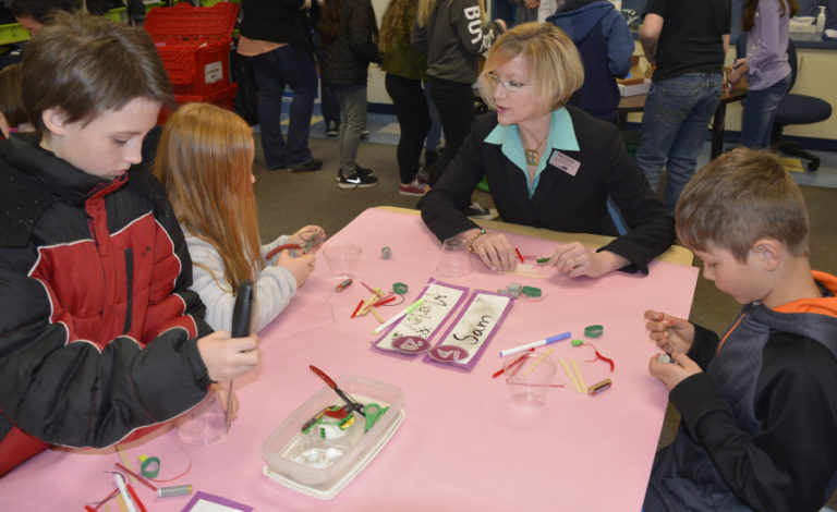 Washougal School District Superintendent Mary Templeton (center) works on a &quot;scribble bot&quot; with Gause Elementary students (from left to right) Micah Erickson, Marley Weaver and Sam Kellar.