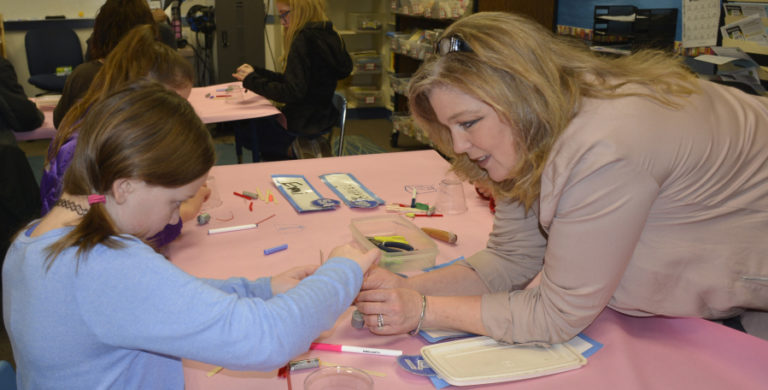Gause Elementary School student Hope Brock works on a &#039;scribble-bot&#039; with the asssistance of principal Tami Culp earlier this month.