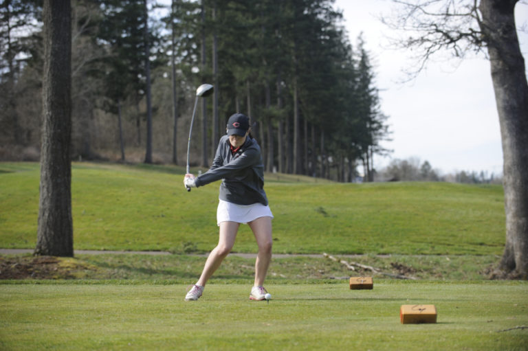 Camas senior Emma Cox uses her powerful swing to drive the ball on a windy day at Camas Meadows.