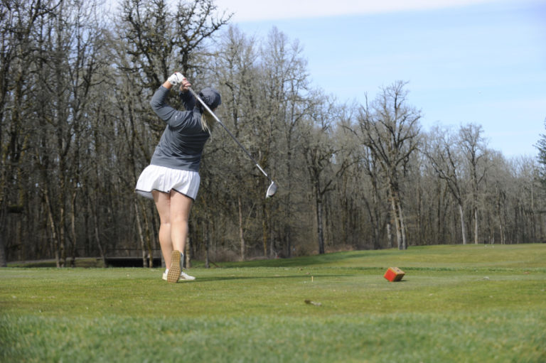 Senior Ashley Clark powers the ball down the fairway at Camas Meadows during a match with Heritage on Tuesday, March 19.