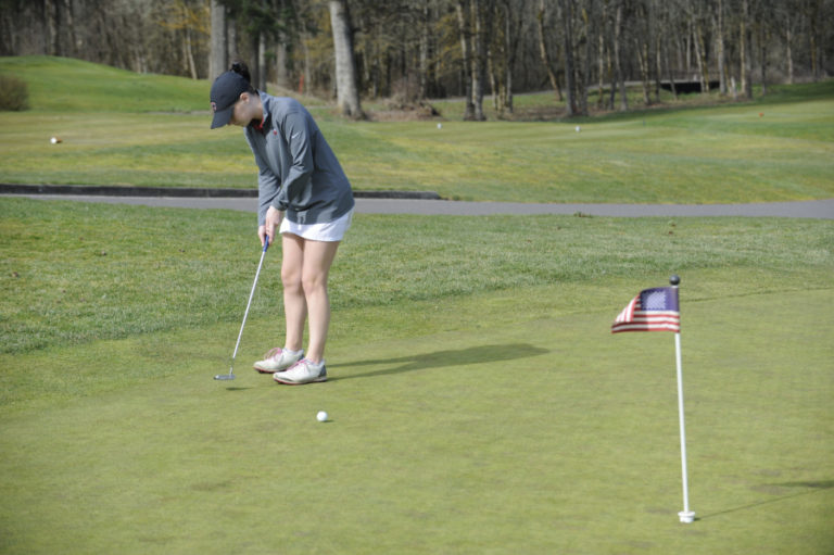 Senior Emma Cox works on her short game at Camas Meadows.