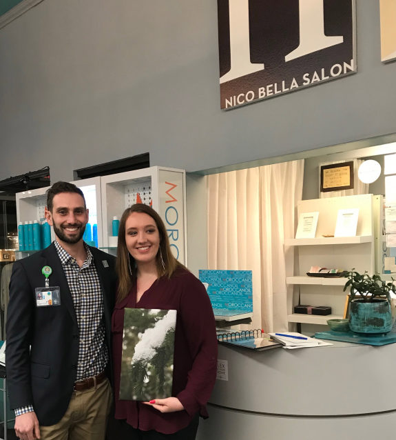 Camas High School senior Emma Hahn (right) stands with John Mohr of Oregon Health and Science University during Hahn&#039;s fundraising photo exhibit at Nico Bella Salon on March 1.