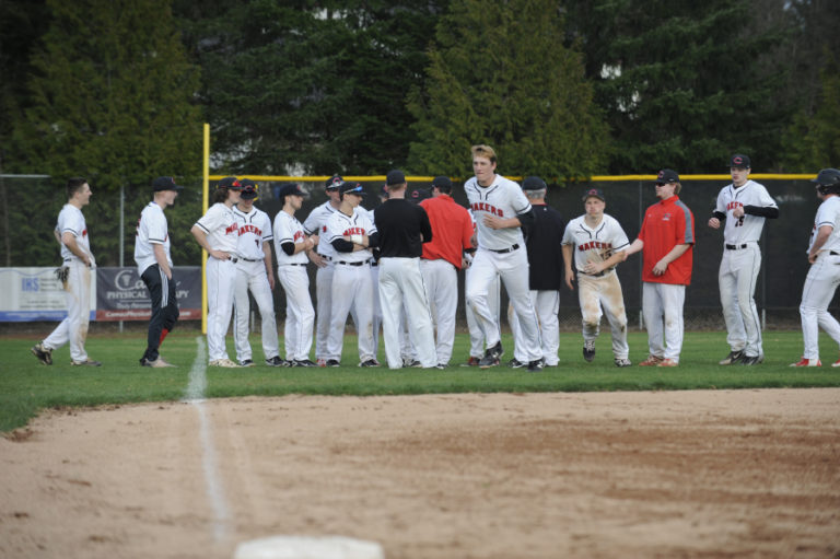 Jake Trupp (center) runs to the diamond from a team celebration after beating Heritage on March 26. Trupp hit a grand slam two days later, helping Camas beat Skyview.