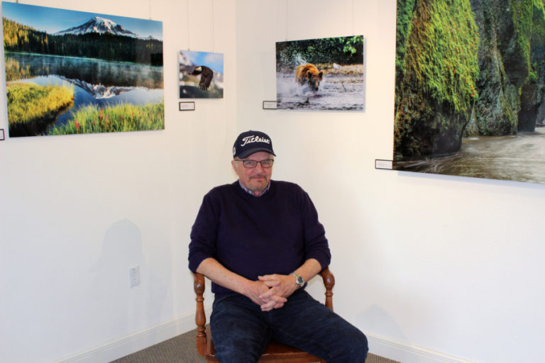 Dale C. Larson, of Camas, sits in the Second Story Gallery in downtown Camas on April 19, surrounded by his photographs of the Pacific Northwest&#039;s most wondrous places and animals.