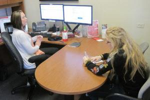 Tiffany Jones (left) introduces Hayes Freedom High School senior Maggie Mack to insurance concepts April 18 at Nathan Loren State Farm Insurance in Washougal. Mack began an internship at State Farm earlier this month. 