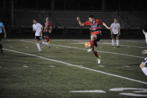 Camas sophomore Will Hansen high steps to keep control while dribbling the ball downfield against Union on April 17.