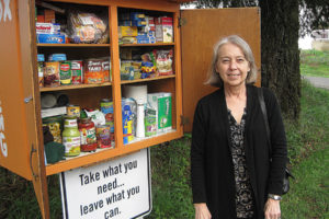 Sharon Carmichael, treasurer of Fern Prairie United Methodist Church, stands next to the church's blessing box, which church leaders installed in November 2018. (Doug Flanagan/Post-Record)