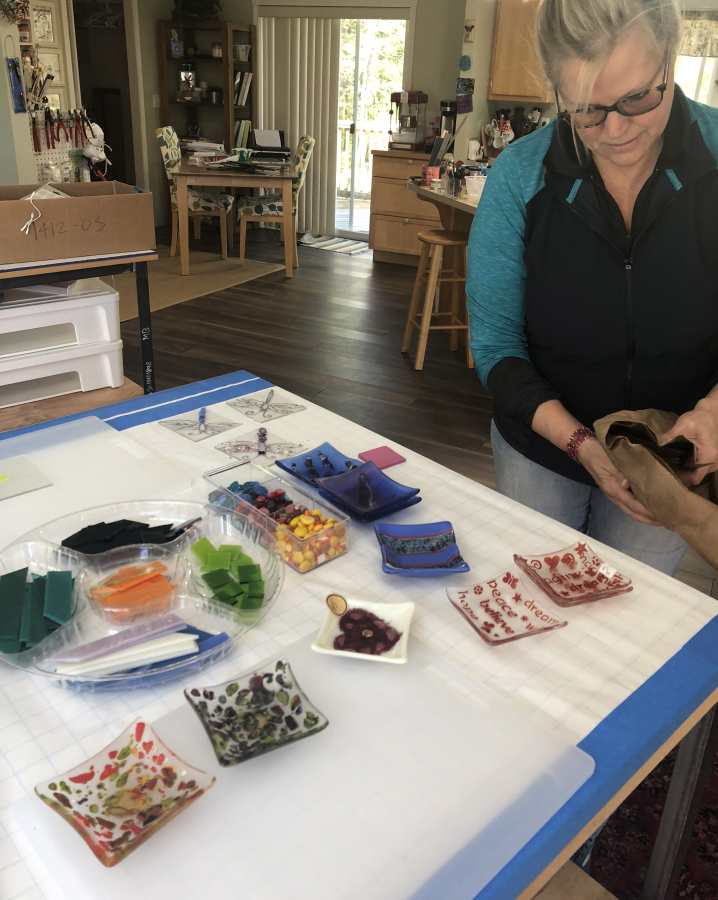 Washougal glass artist Shirley Bishop shows some of the small glass dishes she’s created inside her Washougal art studio on April 29.