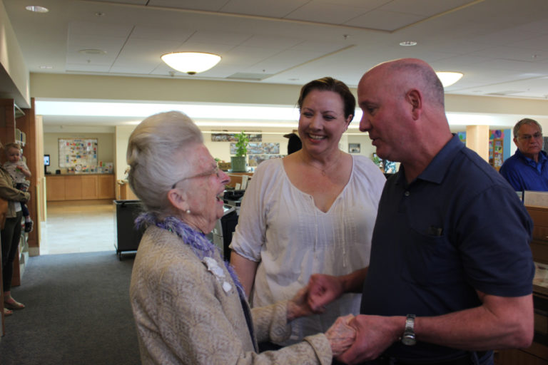 Camas-Washougal Chamber of Commerce Executive Director Brent Erickson (right) asks Virginia Warren to be the 2019 grand marshal of the 2019 Camas Days Grand Parade while Camas Mayor Shannon Turk looks on.