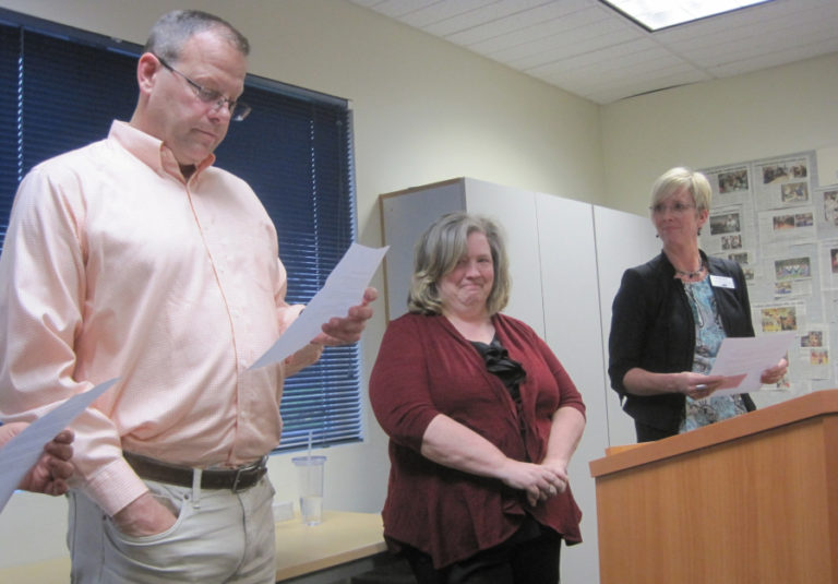 Washougal High School American sign language teacher Tami Blair (middle) listens to a speech delivered by WHS principal Aaron Hansen (left) and career technical education director Margaret Rice at a Washougal School District board of directors meeting April 23.