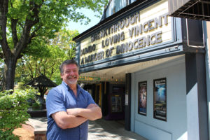Director Shawn Justice stands in front of the Liberty Theatre in downtown Camas, where his latest movie, "A Murder of Innocence," is featured on the marquee. 