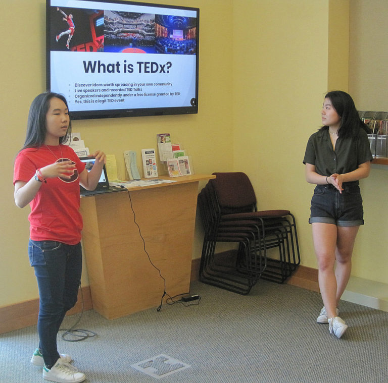 Camas High School seniors Monica Chang (left) and Abby Jiang talk about the upcoming TEDxYouth@Camas event during a speaker workshop May 11 at Camas Public Library.