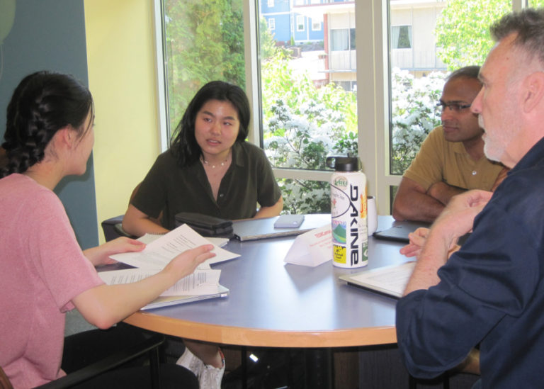 Camas High School students Kacie Lee (left) and Abby Jiang (second from left) talk with TEDxYouth@Camas speakers Bala Krishnamoorthy (second from right) and Tim Hackenberg during a workshop May 11 at Camas Public Library.
