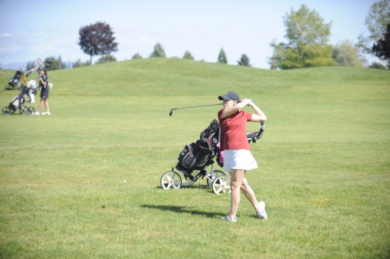 Emma Cox hits an approach shot to the center of the green during day one of the district tournament.