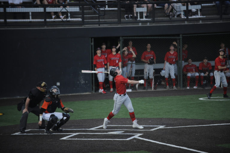The team Camas baseball team watches as Tyler Forner fights off a 90-mph fastball from one of the top pitchers in the state at Propstra Stadium on May 7.