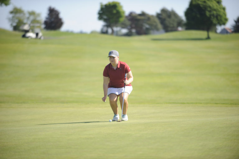 Ashley Clark lines up her putt at number 18.